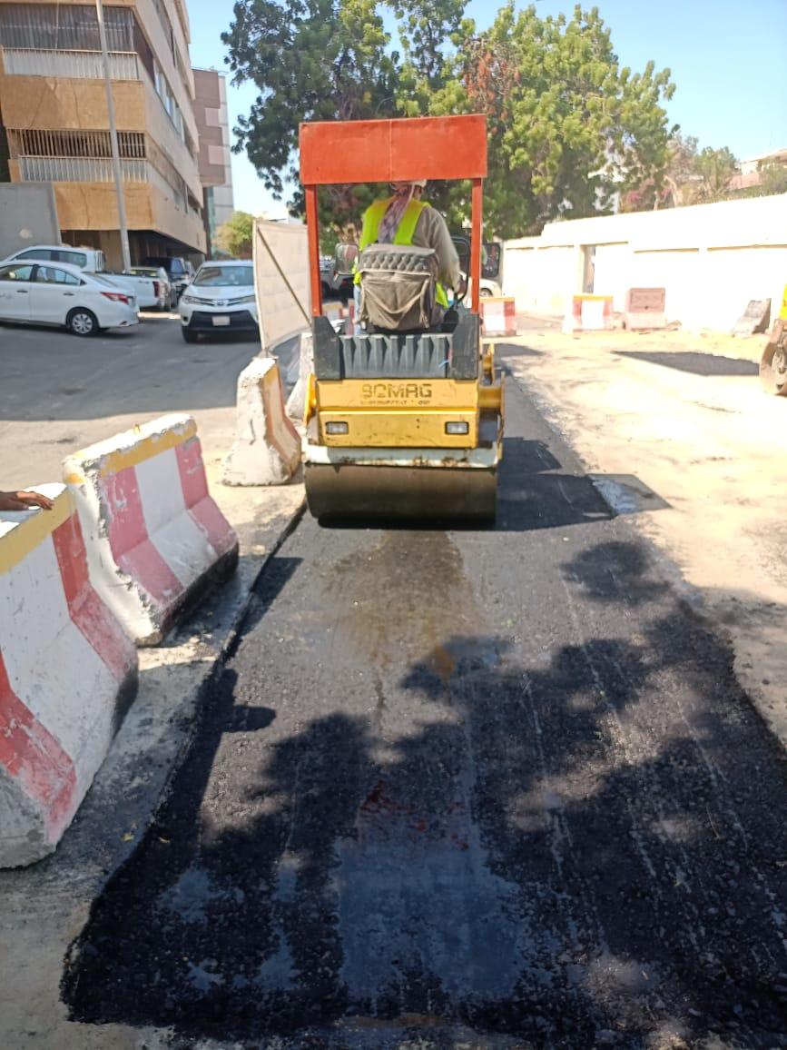 Road roller compacting asphalt surface in Jeddah